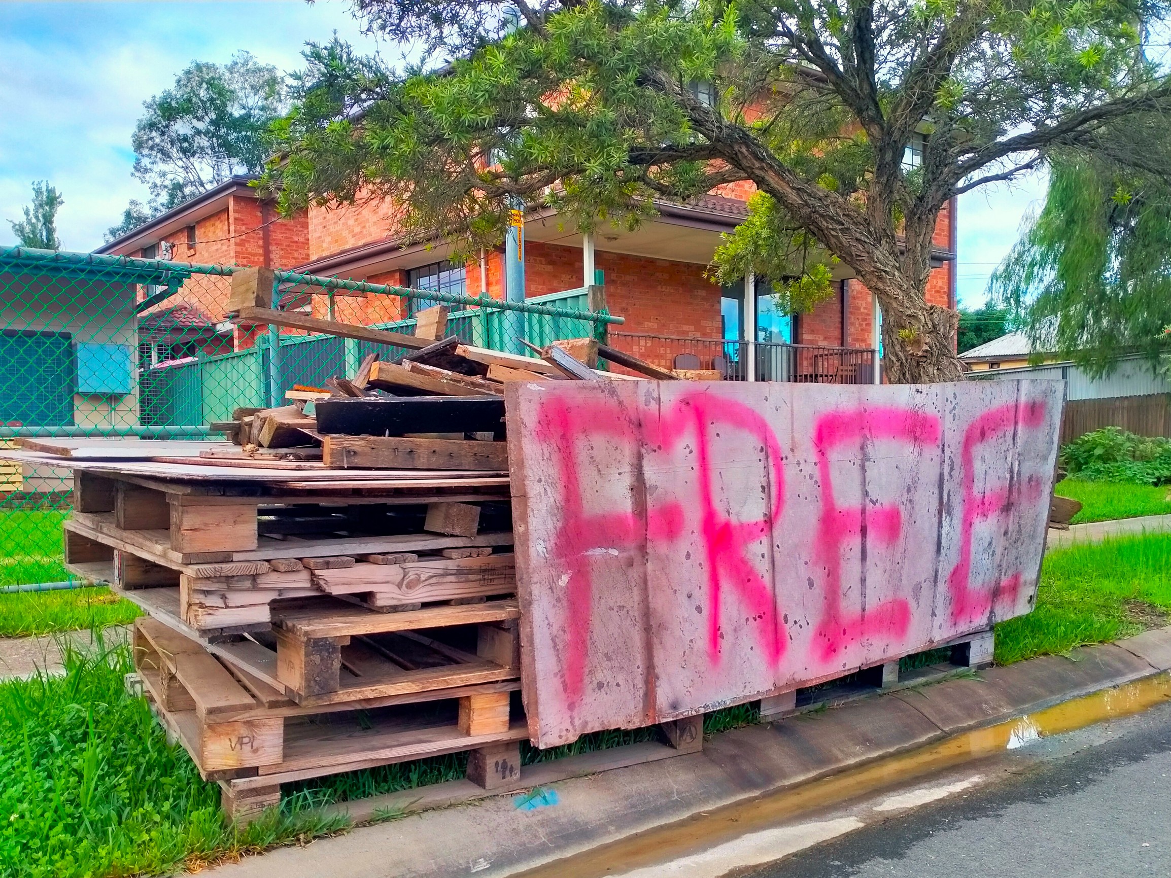 pileof pallets with sign saying free